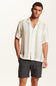Weatherproof Vintage Striped Cotton Airtex Shirt for Men in Seagrass; Man wearing a white button-up shirt and gray shorts on a plain background