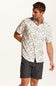 Weatherproof Vintage Linen Rayon Printed Shirt for Men in Cloud Pink; Man wearing a floral short-sleeve shirt and dark shorts on a white background
