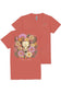 A coral red short-sleeve t-shirt shown from both front and back. The front features a large graphic of a white bull skull surrounded by colorful pink, yellow, and purple wildflowers