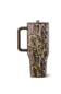 A tall travel mug with a brown handle and lid, featuring a realistic tree bark and leaf camouflage pattern, shown on a white background.