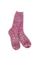 A pair of hand-knit crew socks in a marled pink, purple, and orange yarn, shown against a plain white background.