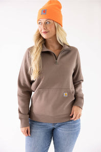 Blonde woman modeling a neon orange Carhartt beanie 