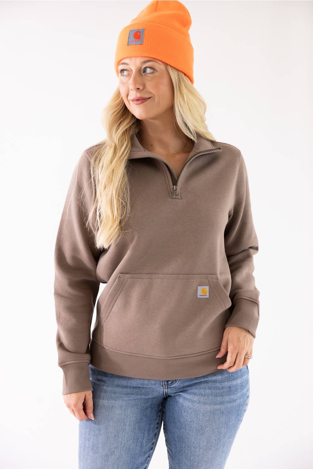 Blonde woman modeling a neon orange Carhartt beanie 