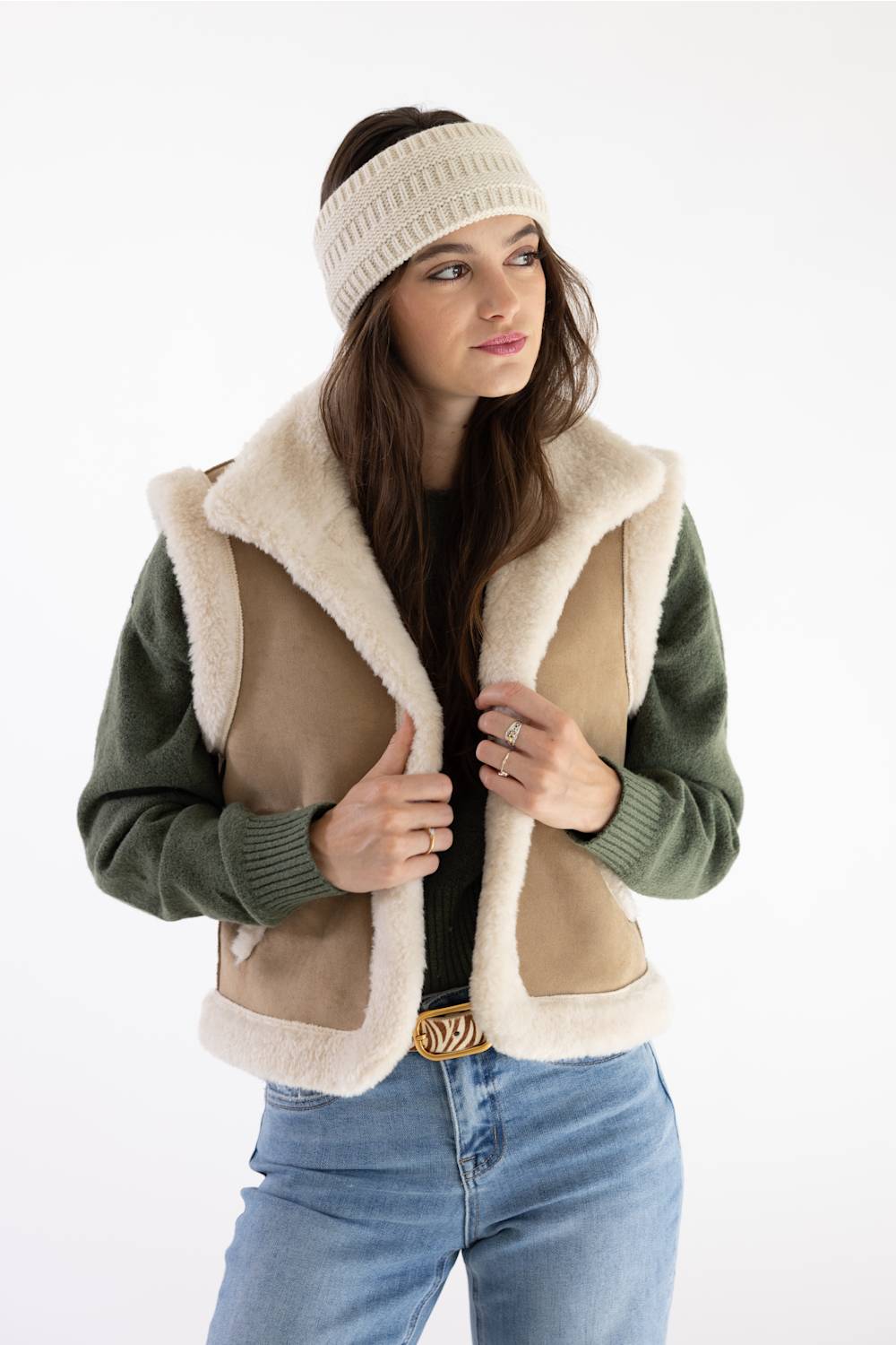 Carhartt Satin Lined Knit Headband in Oat Milk worn with a fleece vest, olive long-sleeve top, and jeans