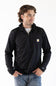 A male model standing against a white background, wearing a black Carhartt Force 1/2 zip hooded sweatshirt over a white t-shirt and blue jeans.