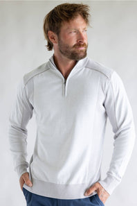 A man wearing a light gray quarter-zip long-sleeve knit sweater with textured ribbed trim, posed against a neutral light gray background.