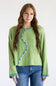 A woman modeling a light green knit sweater with a distinctive wavy blue trim and white button details down the front, paired with blue jeans against a plain white background.