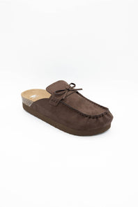 A single dark brown suede mule slipper with a small bow detail on the strap, shown from a side angle against a plain white background.