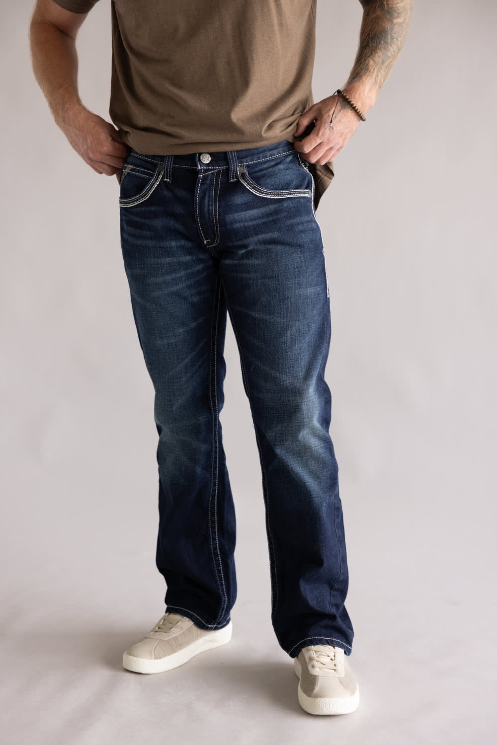 Ariat M5 Slim Stretch Coltrane Straight Leg Jeans for Men; Person wearing blue jeans and a brown shirt on a plain background