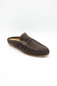A single dark brown suede mule loafer with a strap across the instep and decorative stitching, shown on a clean white background.