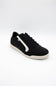 A black low-top sneaker with a white side stripe, black laces, and a white sole, photographed on a seamless white background.