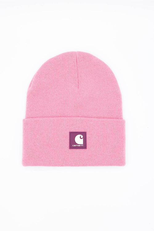A light pink knit beanie hat with a folded cuff, featuring a small square Carhartt logo patch on the front, set against a plain white background.