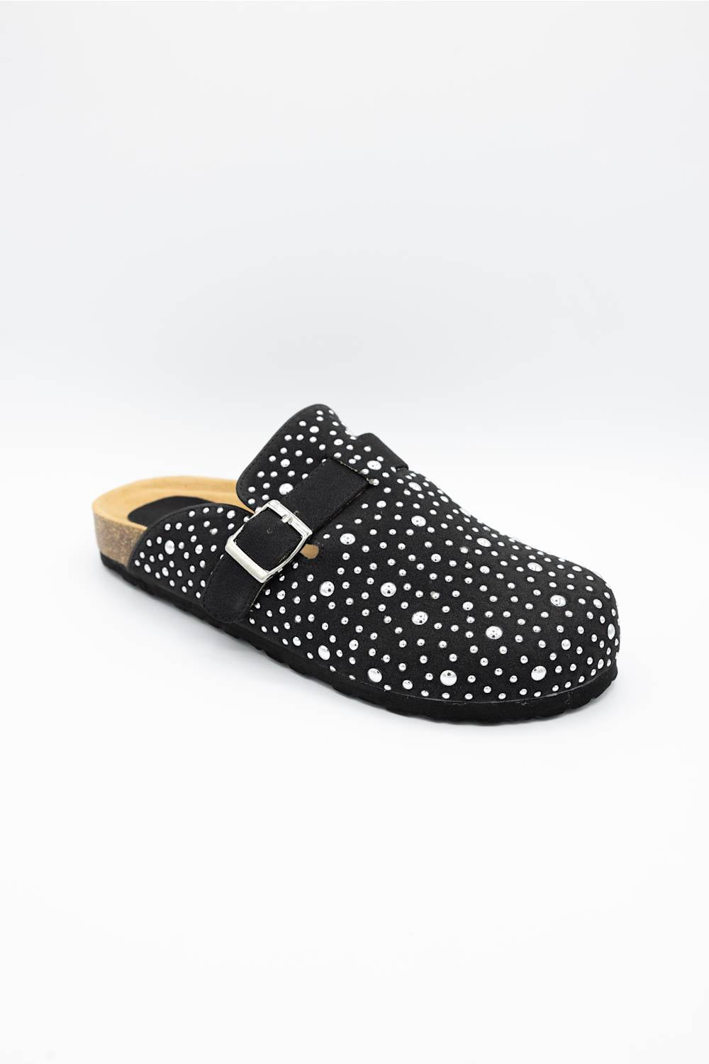 A single black clog-style mule shoe with white polka dots, a black strap with a silver buckle, and a cork-look midsole, shown on a plain white background.