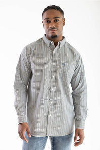 A man wearing a long-sleeve button-down shirt with a small white geometric pattern on a light gray background, paired with blue jeans, photographed against a plain white studio background.