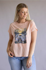 C&C California Lake Tee for Women in Pink; Woman wearing a pink t-shirt with a graphic design on a plain background