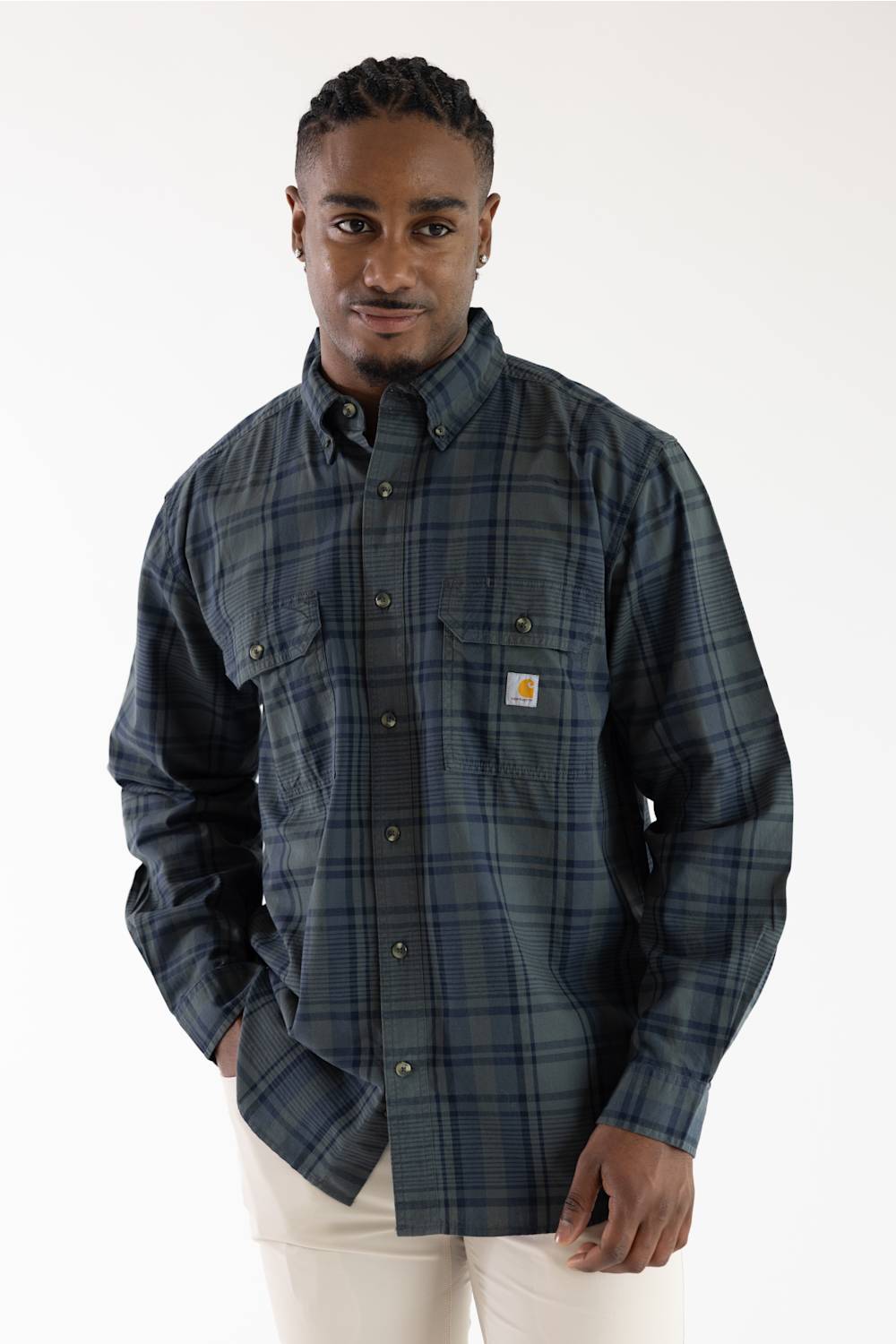 Front view of a male model wearing the Carhartt Fort Loose Plaid Shirt in navy and green plaid with two chest pockets against a white background.