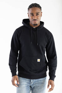 Front view of a male model wearing the black Carhartt Sawyer deer hoodie, featuring a front kangaroo pocket with the signature square Carhartt logo patch.