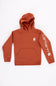 Front view of a boys' burnt brick orange pullover hoodie featuring a front kangaroo pocket, a small white Carhartt logo printed on the left chest, and a bold white Carhartt logo along the left sleeve against a plain white background.