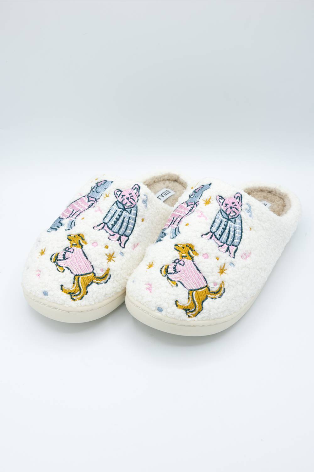 three quarer view of dog wearing pajamas design on comfortable sherpa house slippers