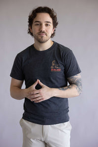 Man wearing a dark t-shirt with a logo against a plain background. The shirt is Burlebo Duck Wild Tee for Men in Heather Black