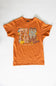 An orange short-sleeve graphic t-shirt laid flat on a white background. The front of the shirt features a detailed graphic spelling 'FALL' with autumn-themed illustrations including pumpkins, checkered patterns, and cowboy boots, with the text 'simply southern' printed below.
