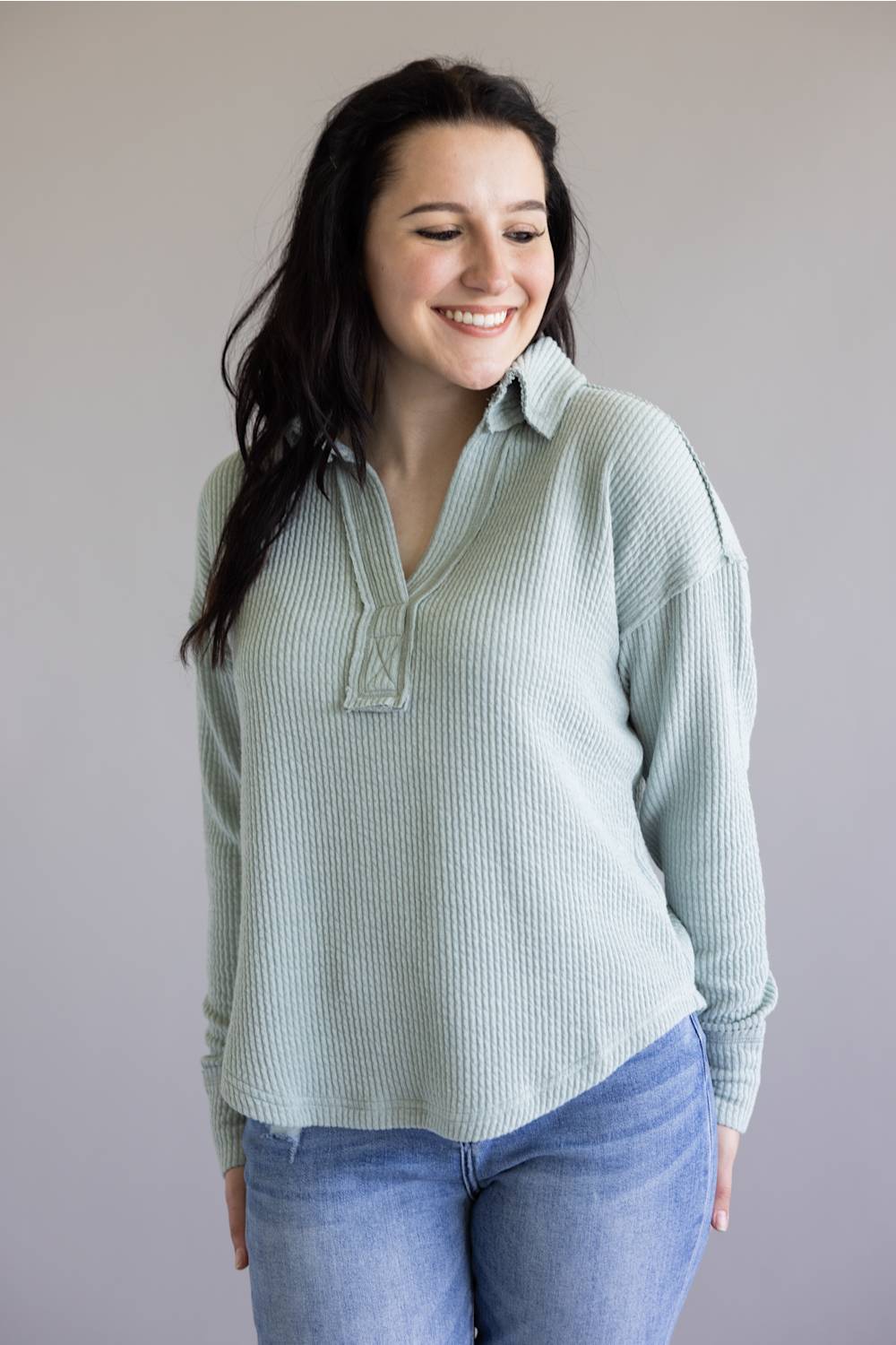 Ribbed v-neck sweater with long sleeves and exposed seams in light teal