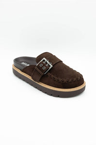 A dark brown suede mule slipper with a braided strap detail and a silver buckle, shown on a plain white background.