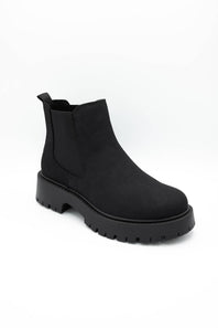 A single black Chelsea-style ankle boot with a chunky lug sole, shown from a three-quarters angle on a plain white background.