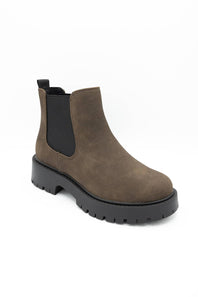 A single brown suede Chelsea boot with black elastic side panels and a chunky black lug sole, shown from a three-quarters angle on a white background.