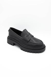 Black dress shoes with textured details on a white background