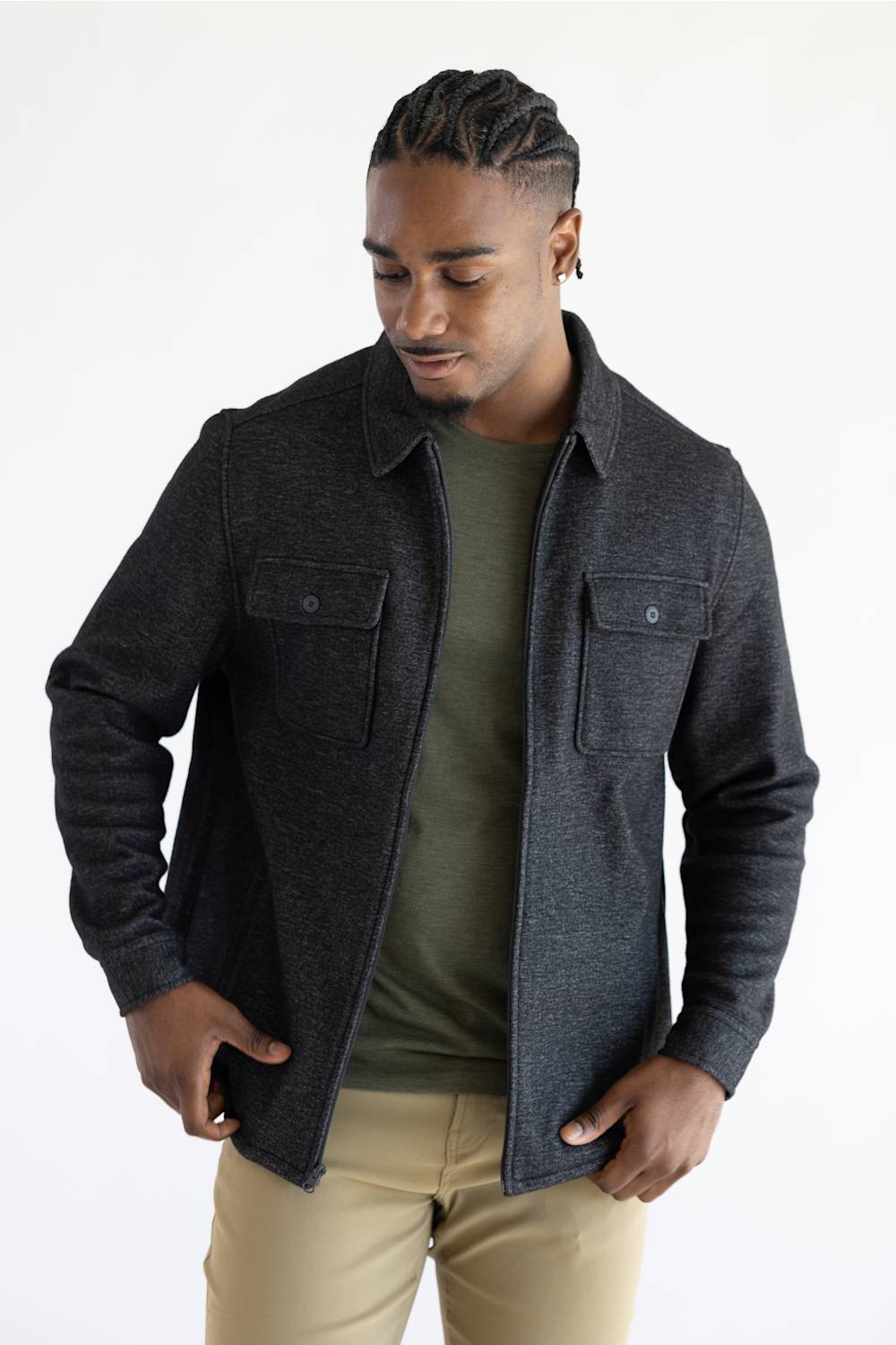 A man wearing a Hallstatt full zip Knit Jacket for Men in Charcoal Grey with two chest pockets.