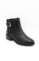 A black leather ankle boot with a low block heel and a gold buckle detail on the side, shown against a plain white background.