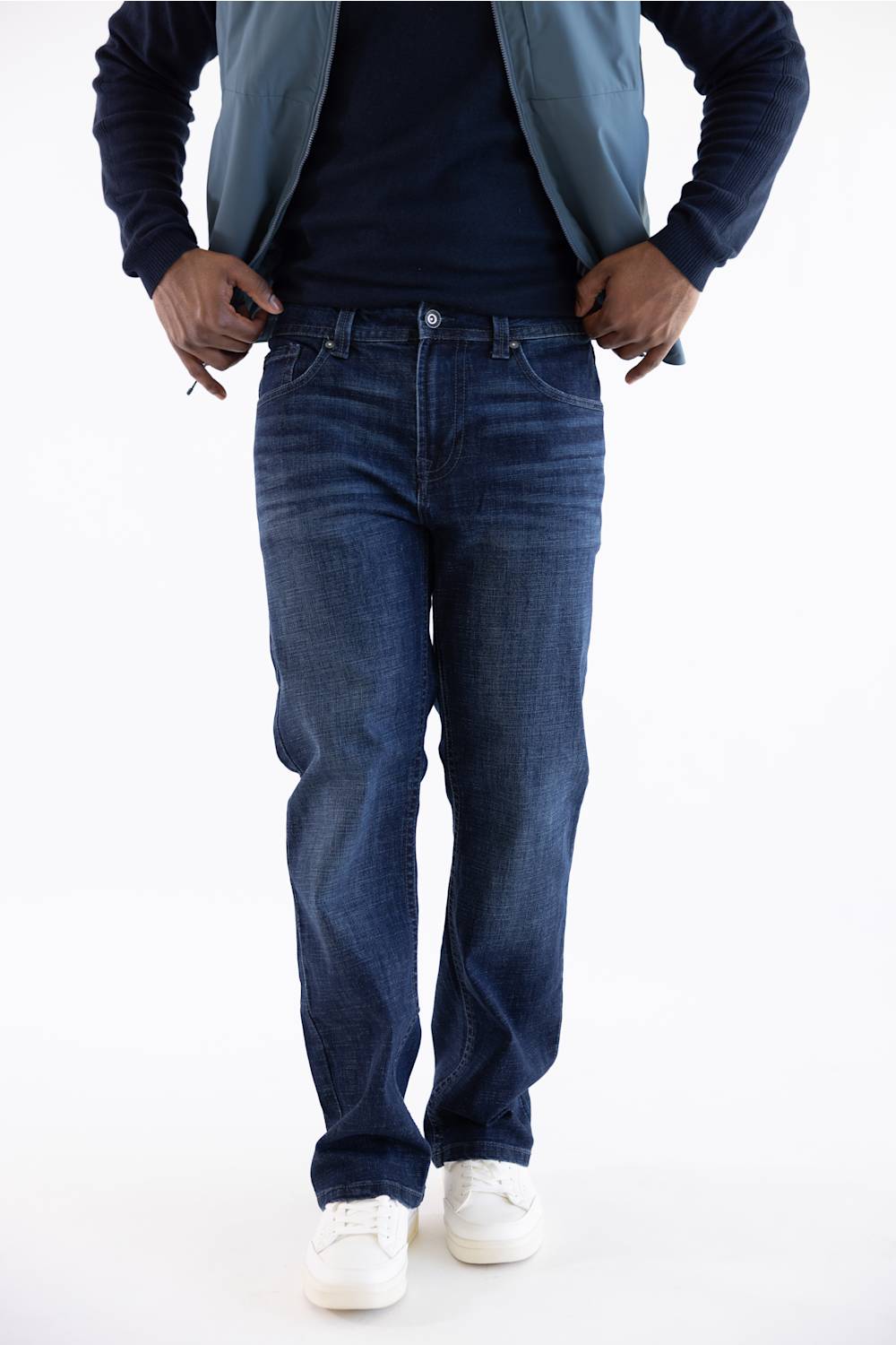 Axel Jeans Men's Landon Bondi Wash Bootcut Jeans worn with a dark shirt, blue jacket, and white sneakers