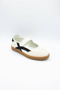 A single white slip-on shoe with a black side stripe and a brown gum sole, photographed on a clean white background.