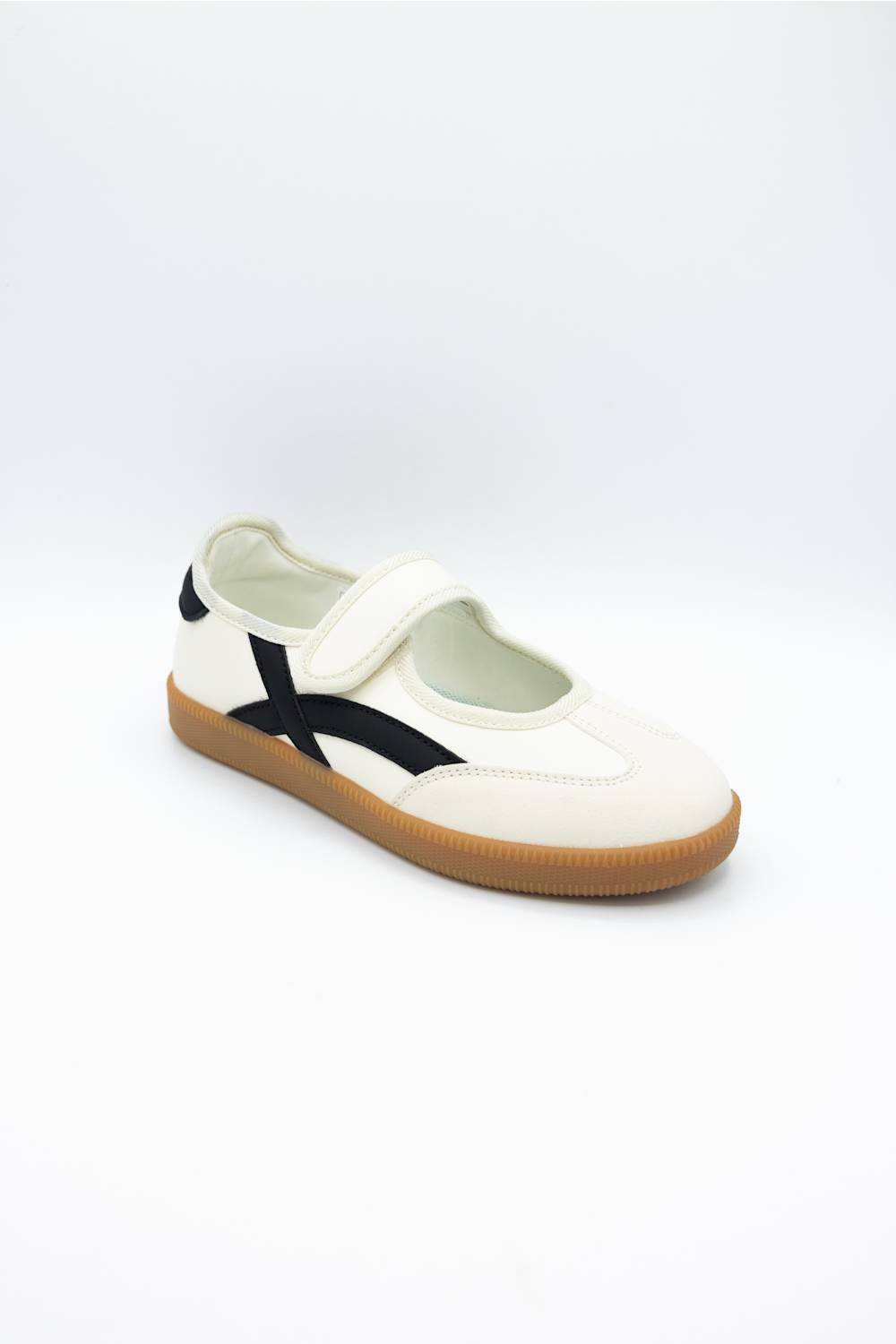 A single white slip-on shoe with a black side stripe and a brown gum sole, photographed on a clean white background.