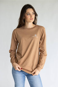 A brown long-sleeve t-shirt with a graphic of three western-style geese on the back, featuring the text 'JUST A SILLY GOOSE' and 'simply southern.' on the back, and 'simply southern.