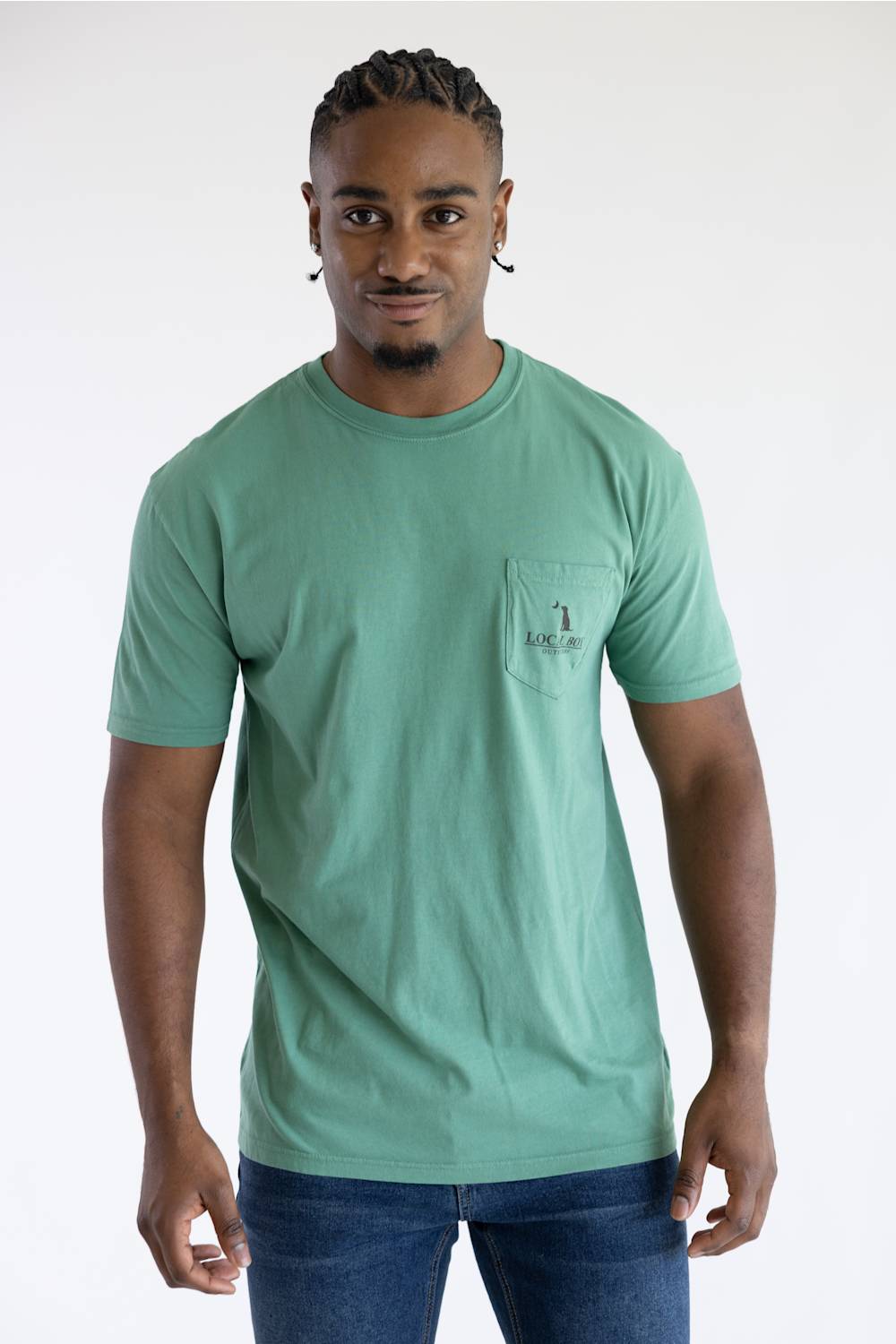 A man wearing a light green shirt with a pocket on the left chest that says local boy.