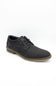 Brown leather shoe on a light gray background