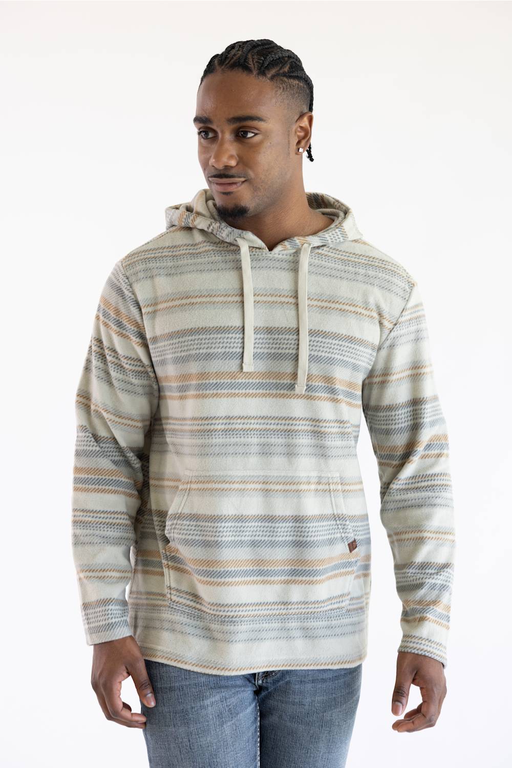 A man wearing a long-sleeve hooded sweatshirt with horizontal stripes in beige, brown, and blue-gray, paired with blue jeans, against a plain white background.