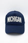 Michigan 3D Stitch Dad Hat in Navy; Navy blue cap with 'MICHIGAN' printed in white on a light gray background