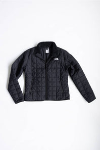 A black quilted puffer jacket by The North Face, laid flat against a clean white background.