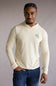 Man wearing a The North Face Adventure Keep Climbing Hoodie in Desert Taupe long-sleeve with a logo on a gray background