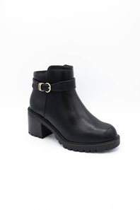 A pair of black leather ankle boots with chunky block heels, featuring a decorative strap with gold-tone buckles on the outer side and a side zipper, shown against a plain white background.

