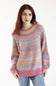 A woman with red hair wearing a long-sleeve knit sweater with horizontal stripes in beige, pink, and light blue, paired with light blue jeans, against a plain white background.