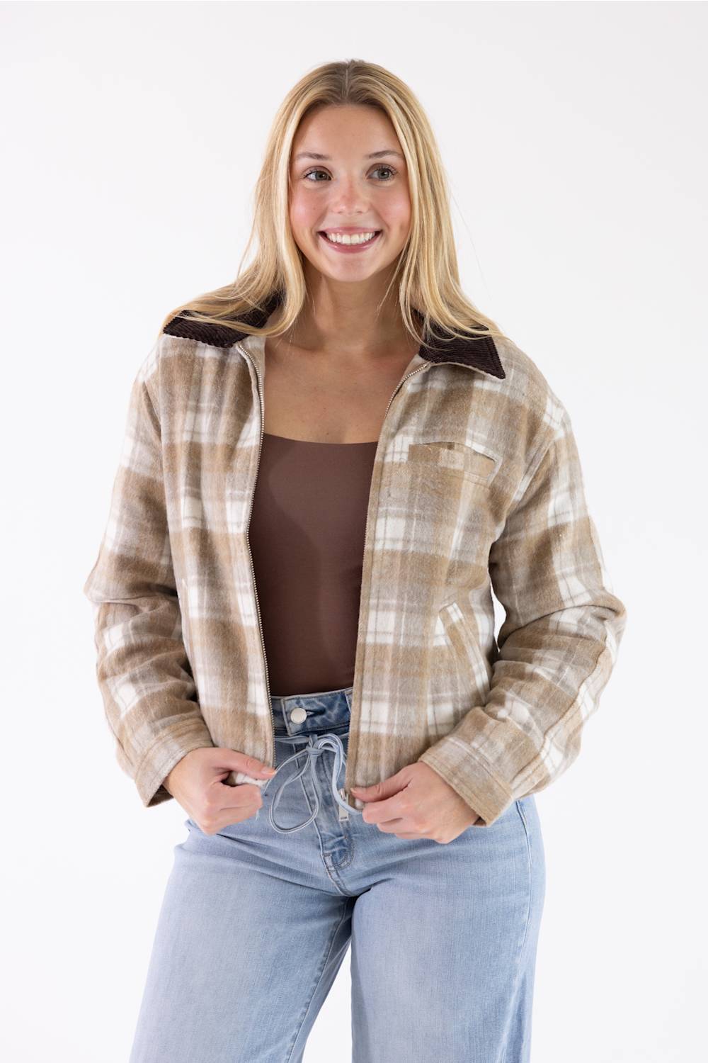 Blonde woman posing in a plaid barn jacket 