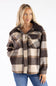 A woman wearing a brown, beige, and gray plaid button-up flannel shirt jacket with blue jeans, photographed against a plain white background.