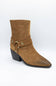 A single brown suede ankle boot with a pointed toe, black block heel, and a decorative strap with brass-tone studs and a ring detail on the side, shown against a plain white background.