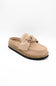 A single slip-on mule shoe in blush suede with a matching fabric bow on the vamp and a cork-textured midsole, shown against a plain white background.