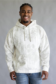 A smiling man wearing a white hooded sweatshirt with a light gray classical painting pattern, paired with blue jeans, standing against a neutral gray studio background.