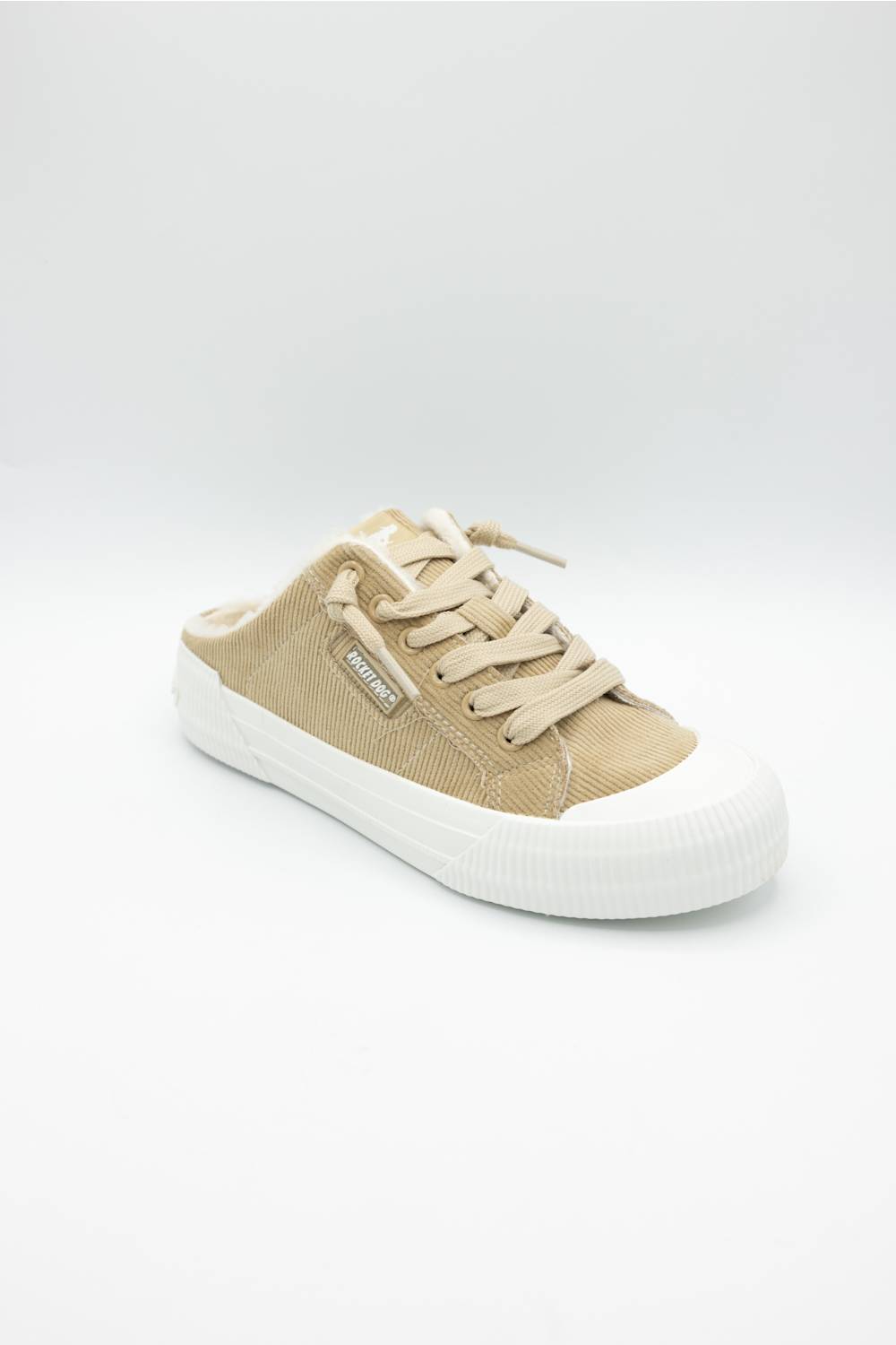 A single low-top slip-on sneaker in beige canvas with a white rubber sole, shown from the side on a light gray background.